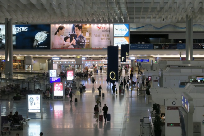 a large airport terminal with people walking