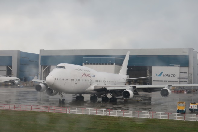 a large white airplane in a hangar