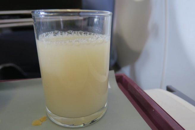 a glass of liquid on a tray