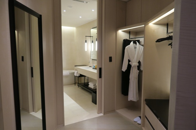 a bathroom with a bathrobe and a sink