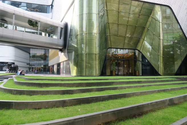 a building with green grass and stairs