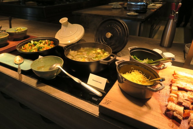 a group of pots with food on a table