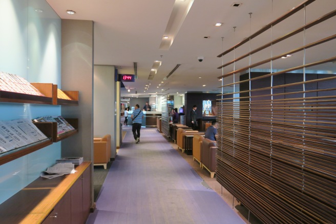 a long hallway with a row of brown wooden slats