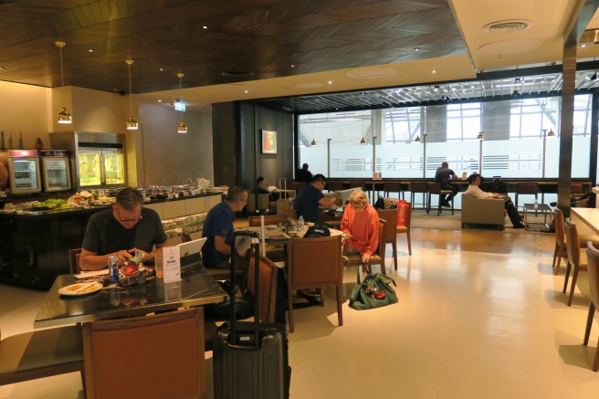 a group of people sitting at tables in a restaurant