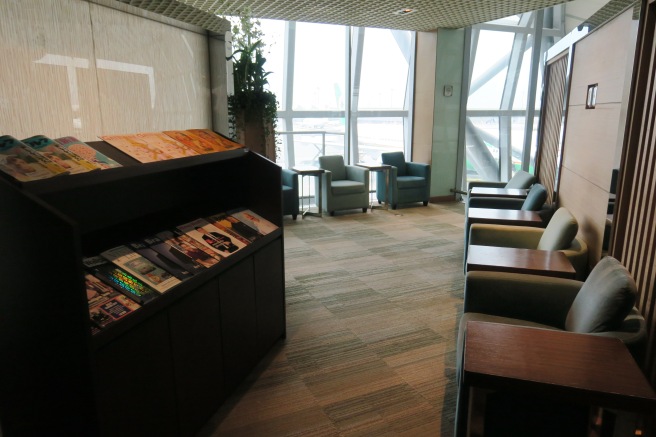 a room with a book shelf and chairs