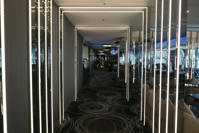 a hallway with lights and a couch