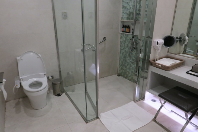 a bathroom with a shower and toilet