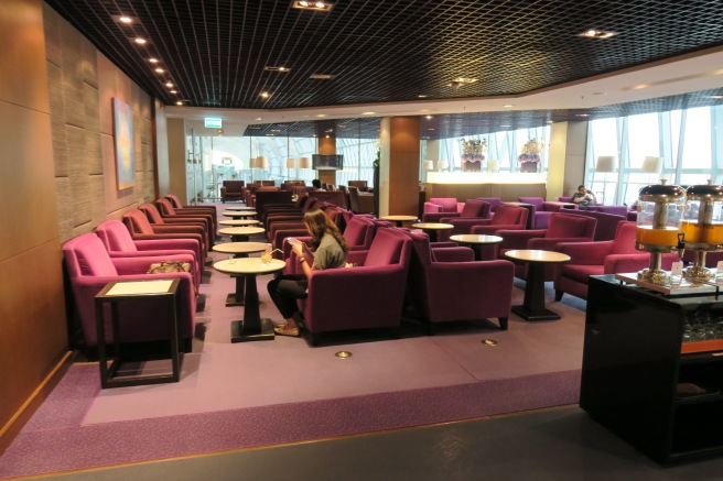 a room with purple chairs and tables