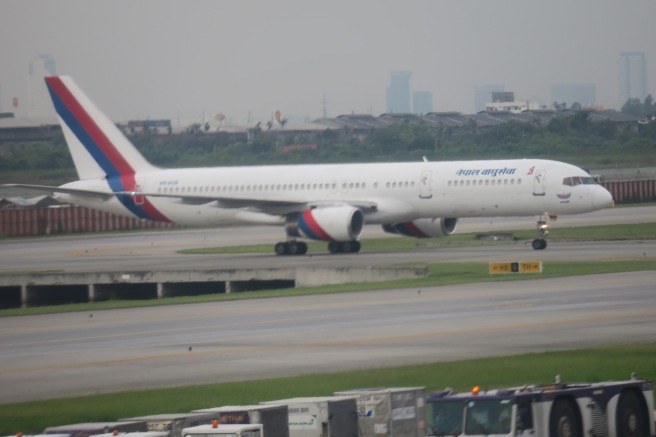 a white airplane on a runway