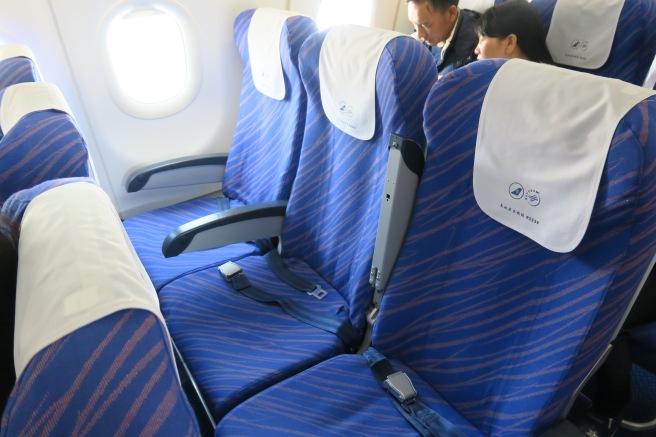 a blue and white seats on an airplane