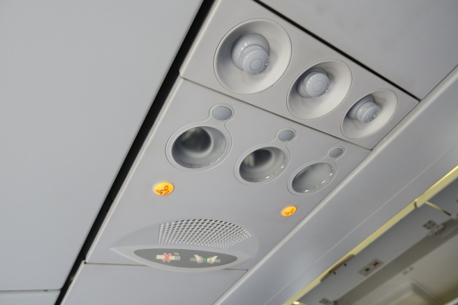 a close-up of a ceiling with lights and a sign