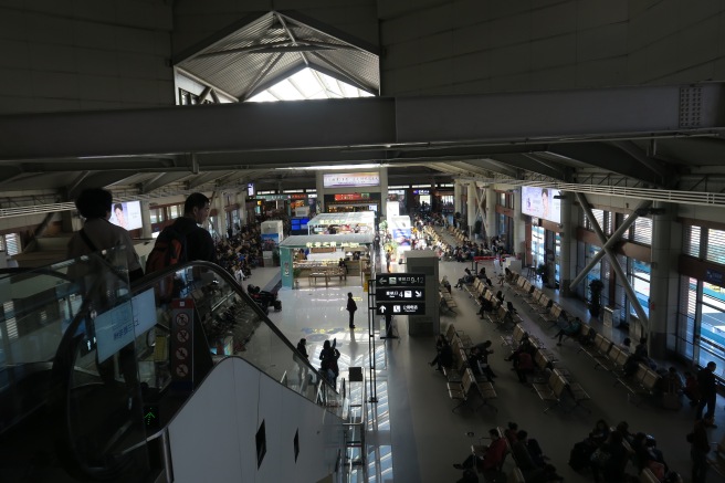 a large building with people sitting in chairs