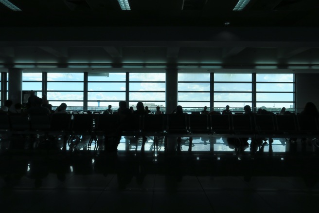 a group of people sitting in a row in an airport