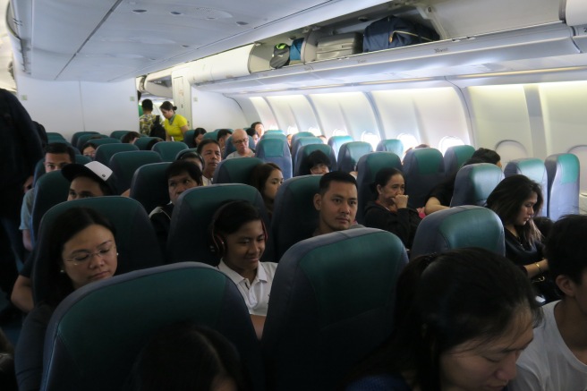 a group of people sitting in an airplane