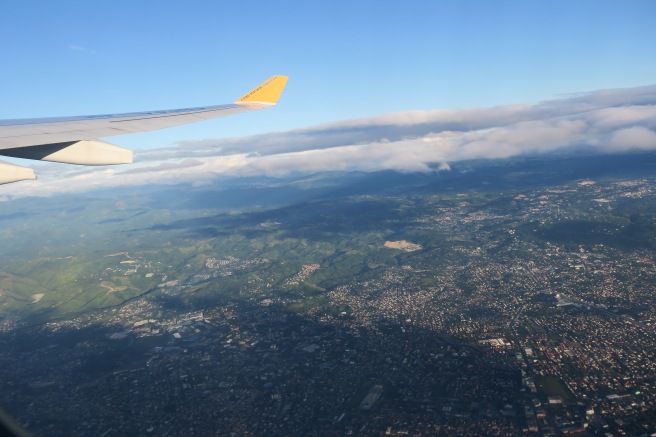 an airplane wing and a city