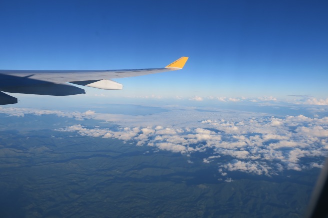 an airplane wing and clouds