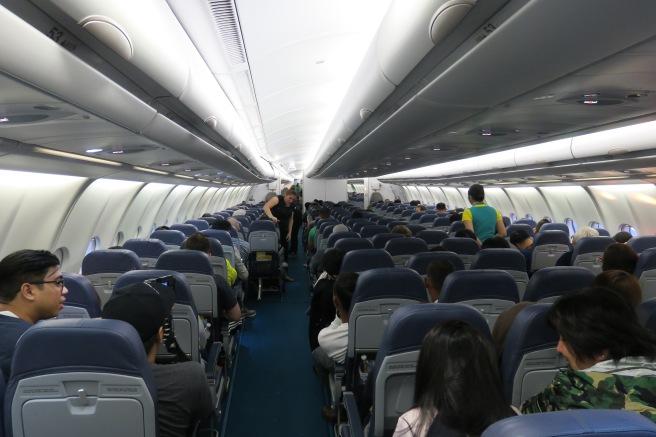 a group of people sitting in an airplane