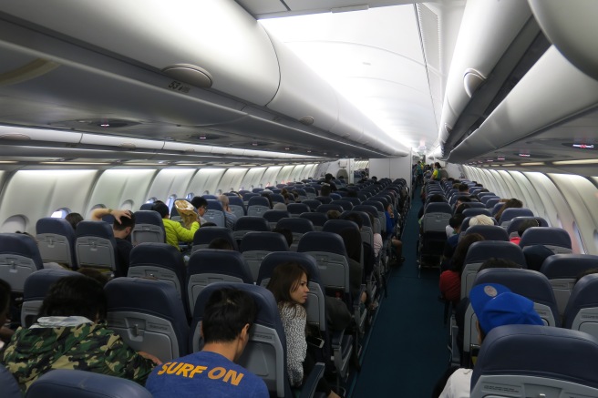 a group of people sitting in an airplane