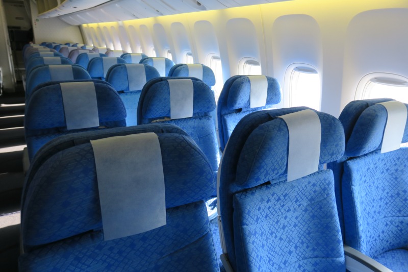 a row of blue seats on an airplane