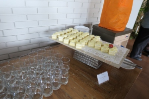 a tray of desserts and glasses on a table