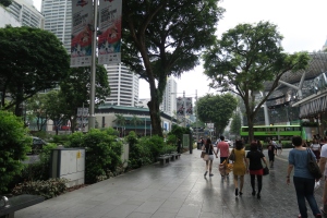 a group of people walking on a sidewalk