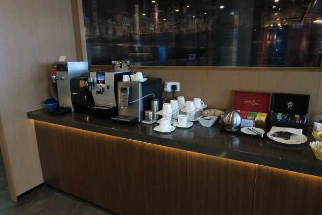 a coffee machine and cups on a counter