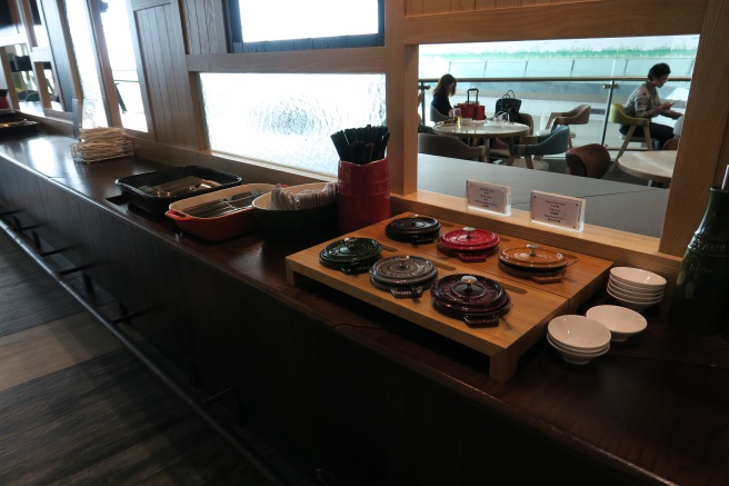 a buffet table with plates and bowls