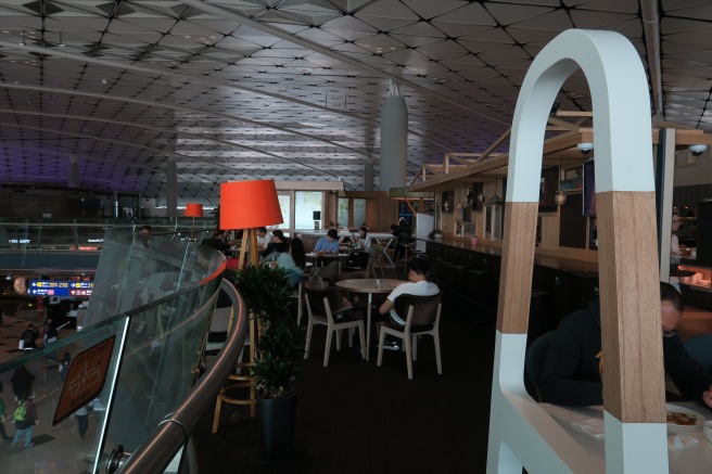 a group of people sitting at tables in a restaurant