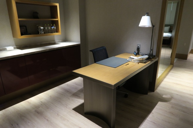 a desk with a lamp and a book on it