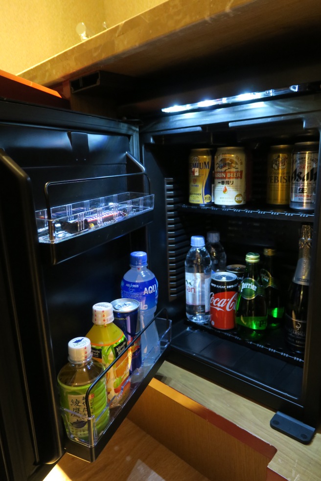 a refrigerator with drinks and cans