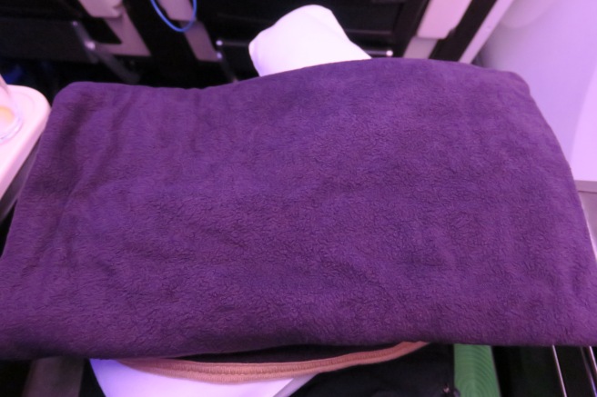 a purple towel on a bed