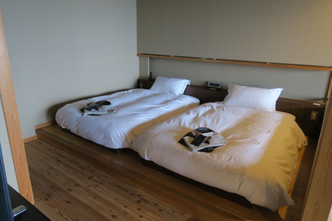 two beds with white sheets on each side