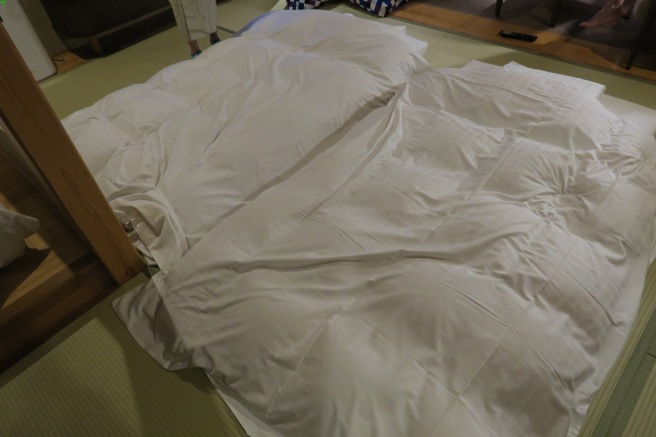 a bed with white sheets