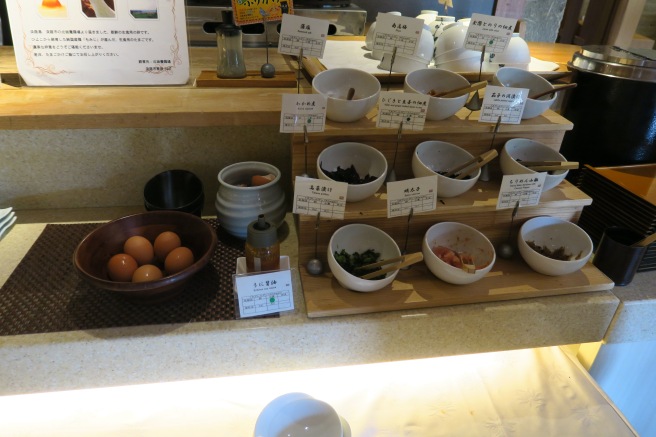 a shelf with bowls of food and labels