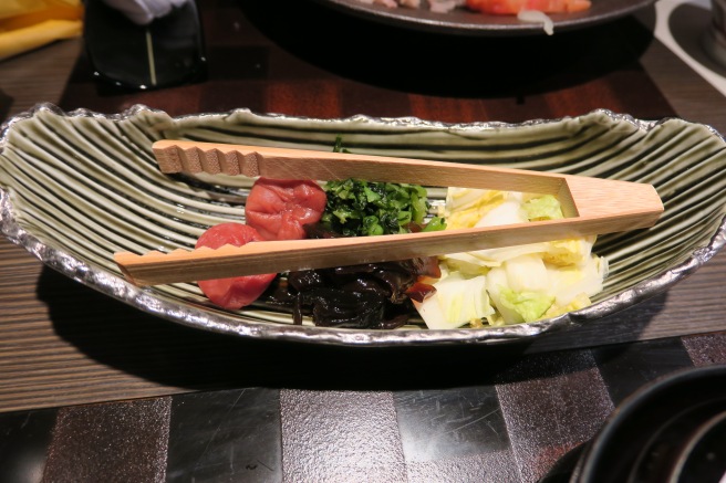 a bowl of food with chopsticks