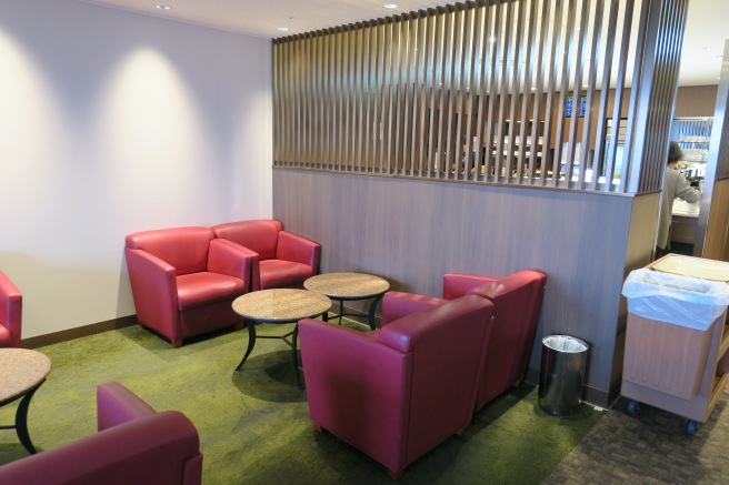 a room with red chairs and a table