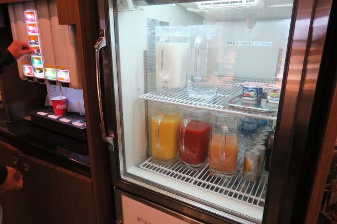 a refrigerator with drinks and beverages