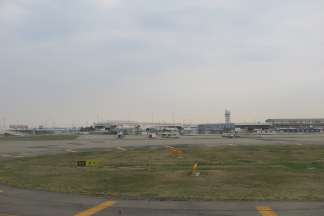 a runway with a building and a bridge