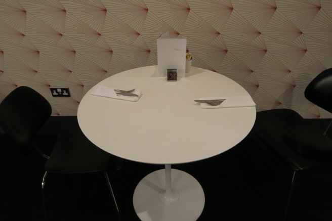 a white table with silverware and napkins on it