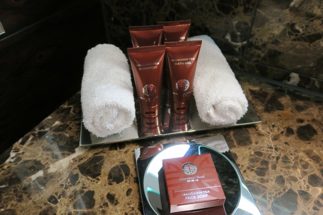 a group of toiletries and towels on a tray