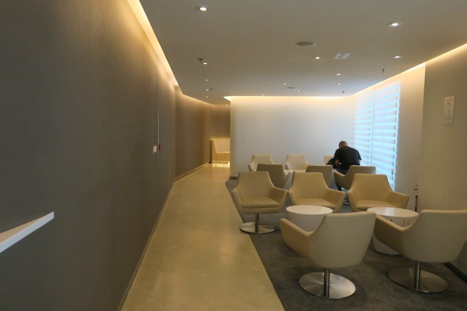 a room with white chairs and tables