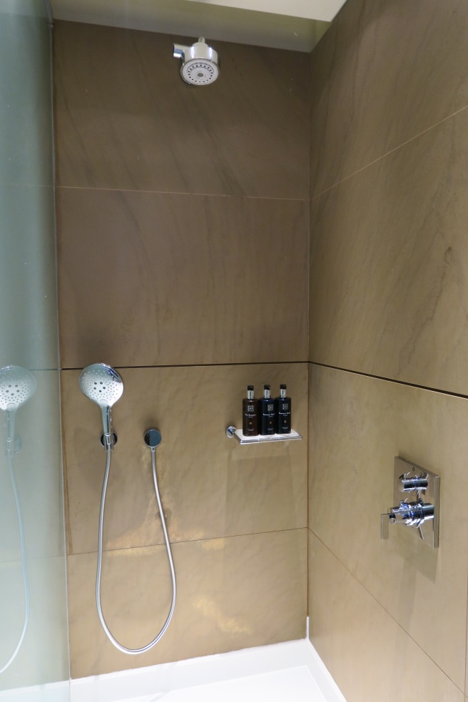 a shower with a shower head and shower head