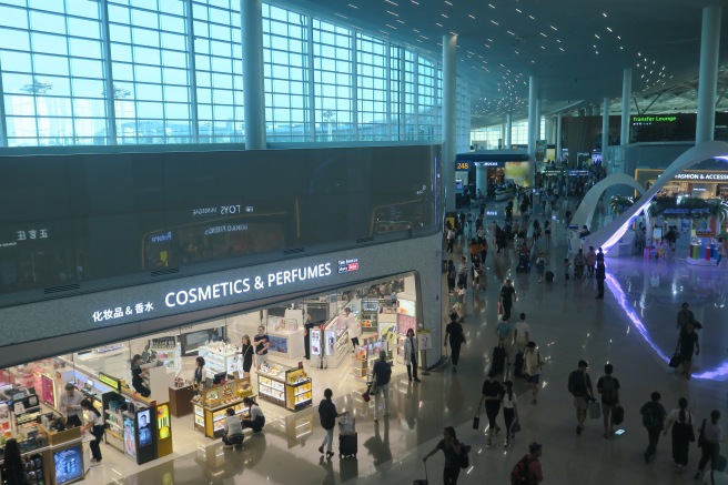 a group of people walking in a large airport