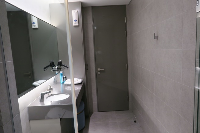 a bathroom with a grey door