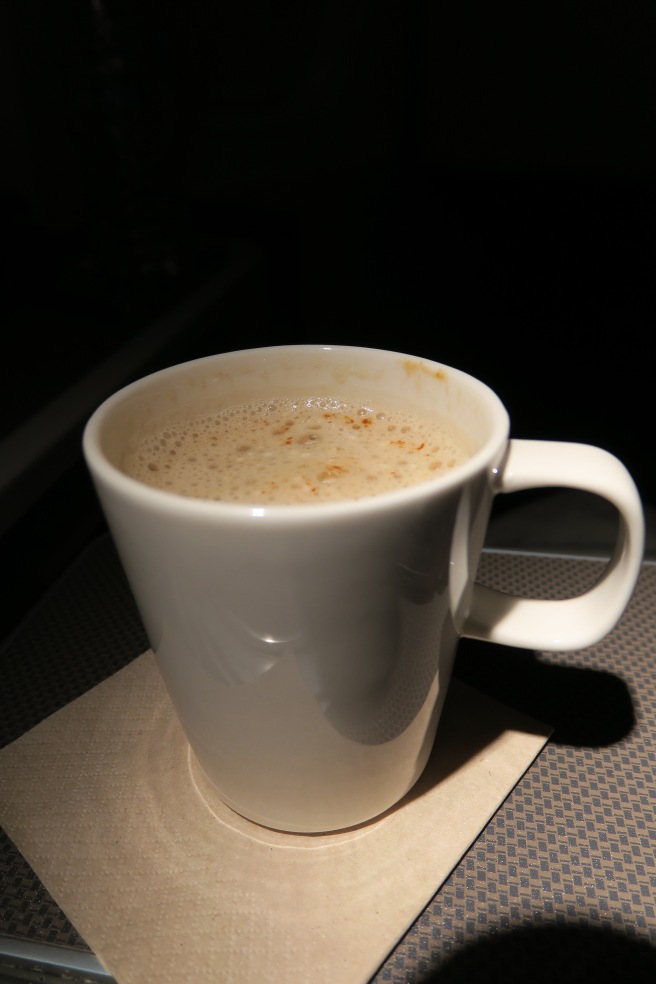 a white mug with a brown liquid in it