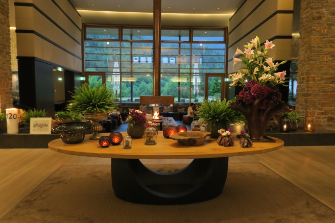 a table with flowers and candles in a room