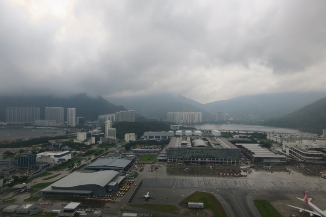 a city with buildings and mountains in the background