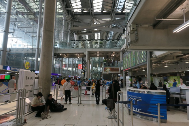 people in a building with people waiting for their flight