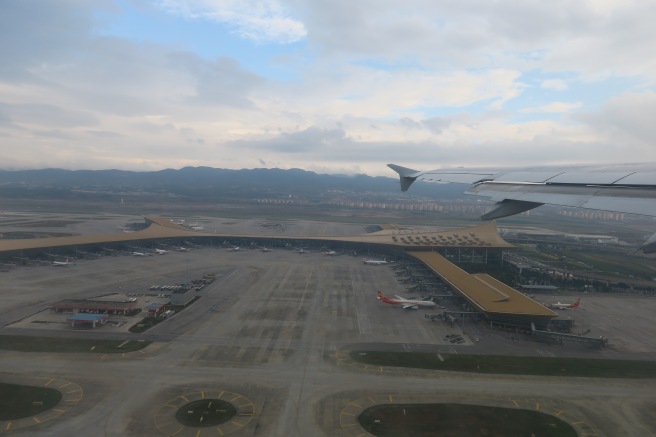 an airplane wing over an airport