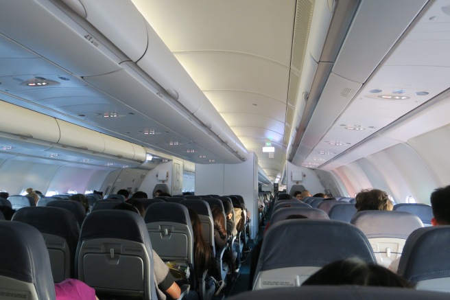 a group of people sitting in an airplane